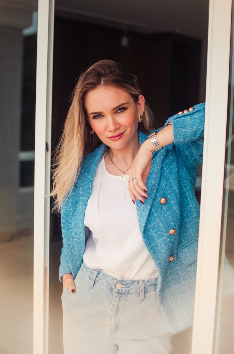 a woman standing in front of a glass door